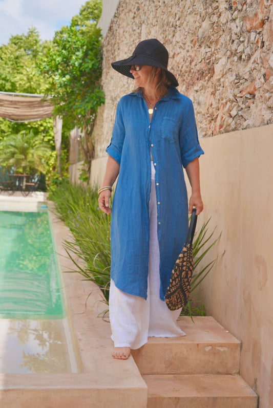 Merida Linen Shirt Dress in blue styled open over white pants by pool